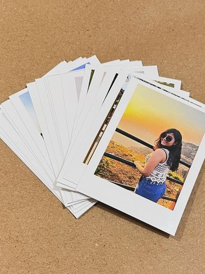 A fanned-out stack of custom polaroid prints, ready to be gifted or used for decoration.