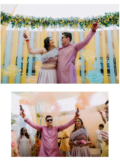 A high-energy shot of the couple using colorful smoke bombs during their Haldi celebration, adding a modern and dynamic touch to the event.