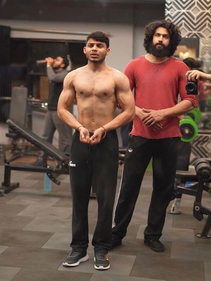 Posing with a client to check his progress. My coaching is hands-on, and I'm there to guide you every step of the way.