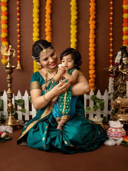 A sweet moment of a mother sharing a playful interaction with her baby, who is holding a piece of "butter."