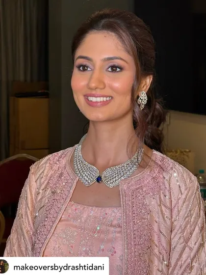 A radiant, smiling shot. The makeup is designed to enhance her natural beauty and give her a luminous glow that looks stunning in person and in photos.