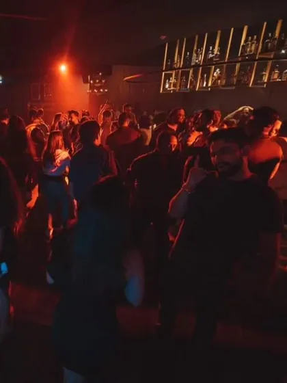 A snapshot of a packed dance floor under the red lights. This is the scene I create every weekend, a space for people to let loose and have a great time.