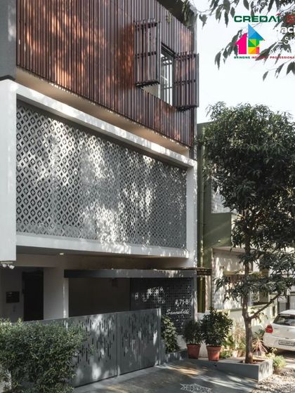 A full view of the '10 x 10 Residence' facade, showing how the different layers and materials work together to create a building that is both private and connected to its environment.