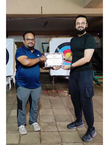 Proudly presenting a certificate to another dedicated student. His focus during the team match on the final day was impressive.