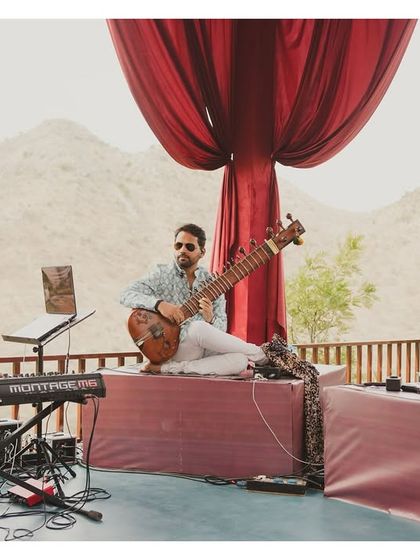 Live folk musicians playing sitar and sarangi, providing an authentic and soulful soundtrack to the daytime festivities.