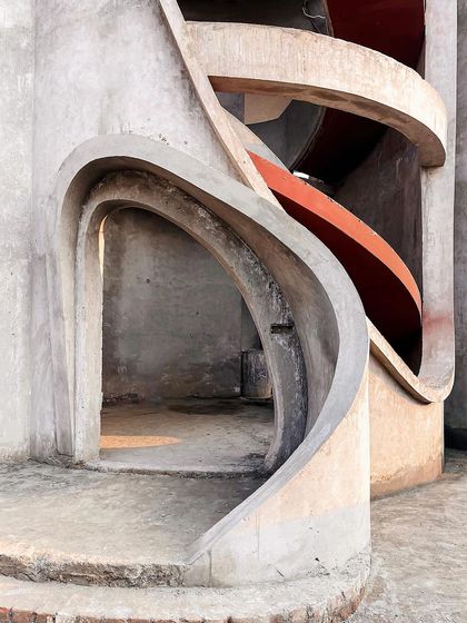 The spiral staircase at the heart of "La La Land," its fluid form ascending with grace even in its raw concrete state.