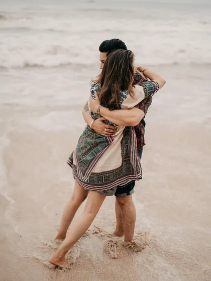 A warm embrace in the gentle waves. This photo captures a moment of pure connection and joy during Komal and Harman's beach photoshoot.