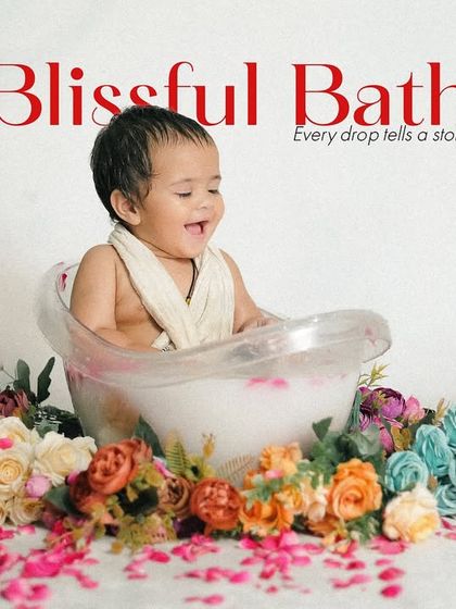 Pure joy during a floral milk bath session. The baby's happy, open-mouthed laugh makes this an incredibly infectious and delightful photograph.