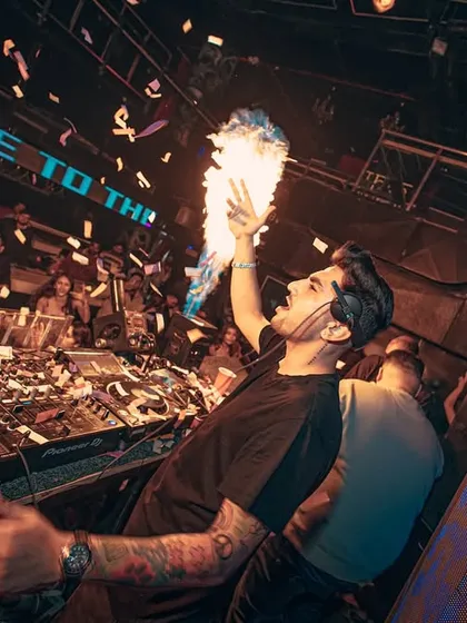 Bringing the fire, literally. This shot from a high-energy club night captures the peak of the party with confetti cannons and handheld pyrotechnics. I make sure every performance is a visual spectacle.