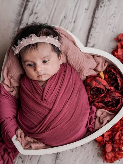 A curious glance. Even when awake, a snug swaddle can help a baby feel secure, allowing me to capture their beautiful, wide-eyed expressions.
