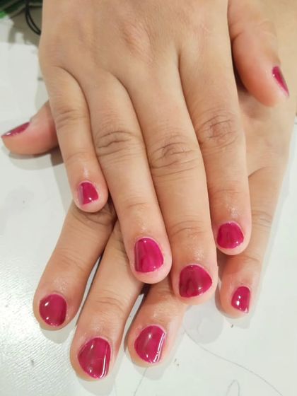 A simple, fresh gel polish manicure on short, natural nails. A clean application of a beautiful solid color like this raspberry pink is sometimes all you need for a perfect look.