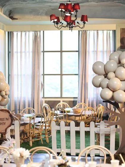 The "Terrarium Garden" at the dragon-themed party, where kids could create their own magical dragon habitats. The area was decorated with balloon trees and a white picket fence.