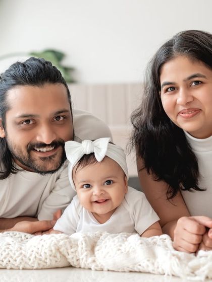 A lifestyle family portrait with everyone relaxing on the floor together.