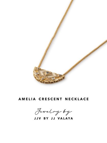 The Amelia Crescent Necklace by JJ Valaya showcases a half-moon design adorned with intricate Art Deco patterns. It's a delicate yet impactful piece for daily wear.
