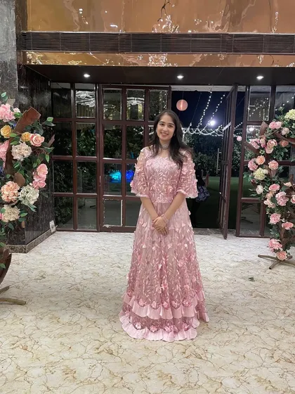 The same stunning pink floral embroidered outfit, seen from a wider angle. It’s perfect for an outdoor evening function, like a reception or sangeet.