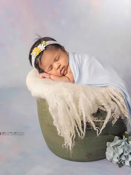 A softer, more delicate take on the bucket pose. The light blue wrap and matching hydrangeas create a serene and gentle mood.