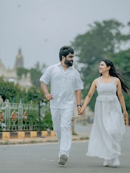 A candid shot of a couple walking and talking, capturing a natural and relaxed moment during their pre-wedding shoot.