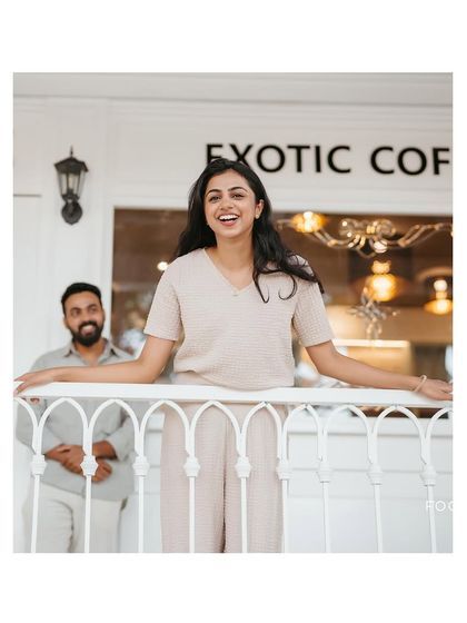 A bright and happy portrait of the bride-to-be on a cafe balcony. The genuine smile and relaxed pose capture a moment of pure joy.