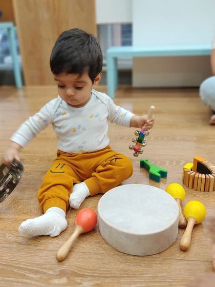 It is a joy to see children surrounded by instruments, figuring out how each one works. Little Yohaan is busy exploring a tambourine, maracas, and a drum, a true multi-instrumentalist in the making.