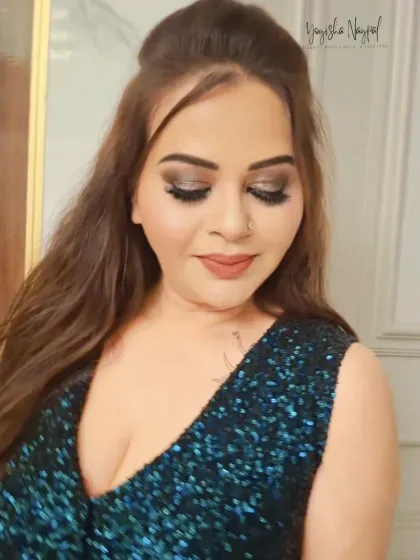 A close-up on a glamorous smokey eye look. The shimmer on the lids adds a touch of sparkle, perfect for a night out.