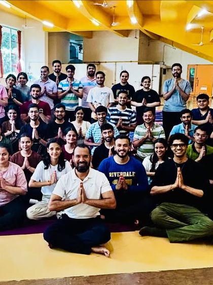 A group photo with MBA students after a successful yoga session. I help future leaders learn to manage stress and maintain balance as they begin their demanding careers.