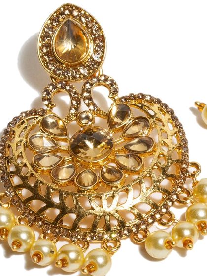 A closer look at the art we craft. This detailed shot of a kundan and pearl earring was captured in-house in our mini studio, because we believe beauty begins at the roots.