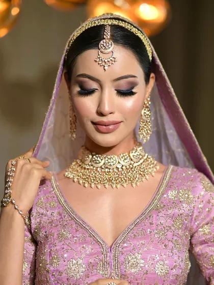 A beautiful shot of the bride with her eyes closed, showing the seamless blending of the eyeshadow. The look is polished and perfect for wedding photography.