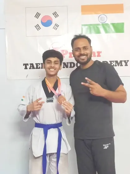 A junior student proudly displays his bronze medal from the 40th Junior Delhi State Taekwondo Championship.