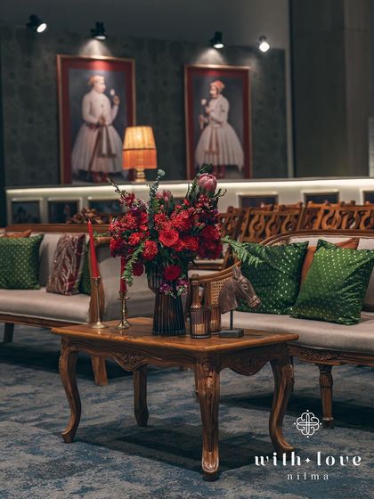 A seating area near the bar, featuring classic furniture and decor inspired by the paintings on the wall. The entire space is a carefully curated narrative.