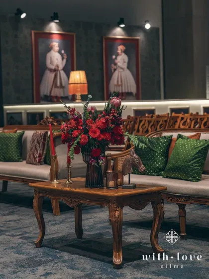 A seating area near the bar, featuring classic furniture and decor inspired by the paintings on the wall. The entire space is a carefully curated narrative.
