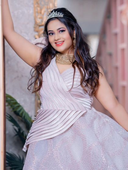 A confident and joyful pose in our designer rental gown, perfect for capturing unforgettable moments.