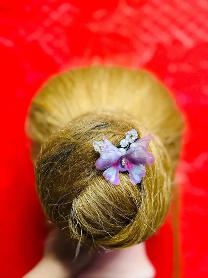 This is the same elegant bun, showing how a small accessory can completely elevate a simple updo. We explore various accessory options in my hairstyling classes.