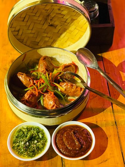 Our Devil Dumplings, served steaming hot in a traditional bamboo basket.