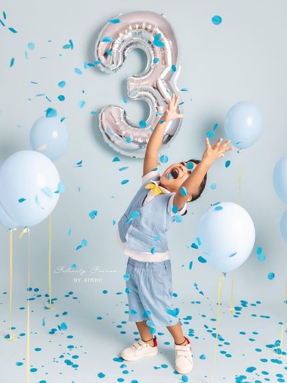Pure joy and excitement! This three-year-old is loving the confetti shower during his birthday photoshoot.