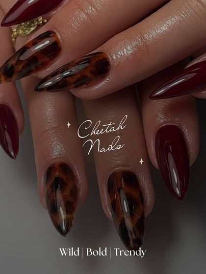 Unleash your wild side with these cheetah print nails. Paired with a deep burgundy, this design is the perfect mix of trendy and bold.