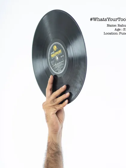 Rahul, a 31-year-old DJ, holding a vinyl record. The "What's Your Tool" series was a personal project to give a glimpse into the hands responsible for the work we see and hear every day.