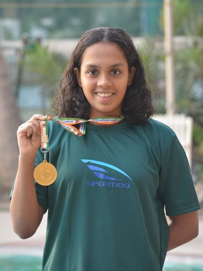Nirmayee Ambetkar proudly displays her gold medal after winning the 200m Butterfly Stroke at the SGFI Nationals 2024.