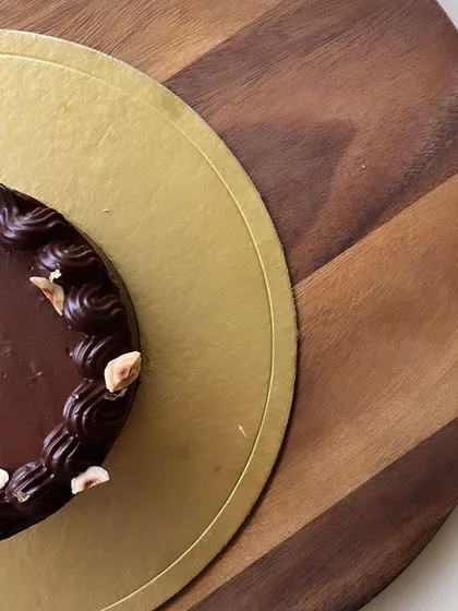 An artful shot of our Double Chocolate Baked Cheesecake, highlighting its smooth finish and rich color.