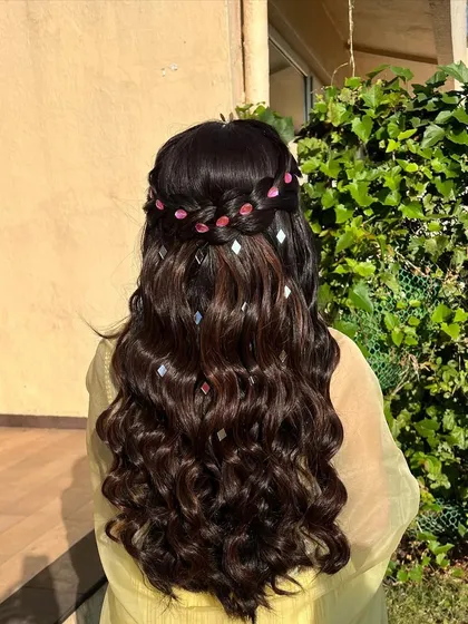 This hairstyle proves that small details make a big impact. The combination of a waterfall braid and scattered shiny accessories creates a unique and eye-catching look.
