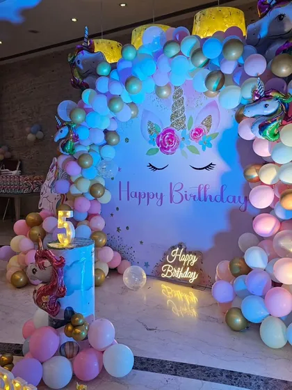 I specialize in creating magical themed birthday parties for kids. This unicorn-themed setup includes a custom backdrop, a multi-colored balloon arch, character cutouts, and marquee lights to spell out the birthday girl's name.