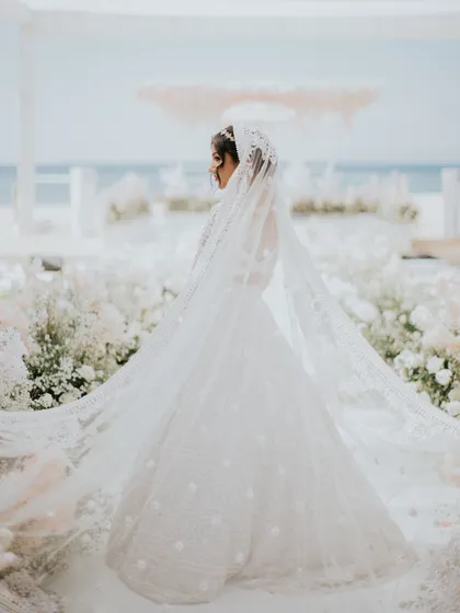 A bride and her veil. The stunningly long and intricately embroidered veil of this Manish Malhotra lehenga created a truly dramatic and unforgettable bridal entrance at this Bali beach wedding.