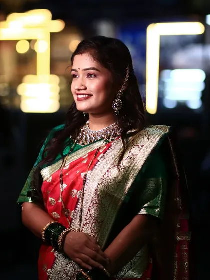 A beautiful candid shot with a lovely bokeh background. The bride's makeup looks stunning even in low light.