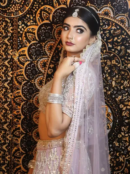 A beautiful, soft-glam bridal look perfect for a reception or engagement. The photo highlights the flawless base and intricate details of the makeup.