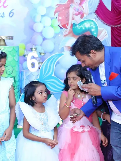 This is a close up moment during a card trick with some curious audience members. I love getting right into the crowd to show them that the magic is happening right in front of their eyes.