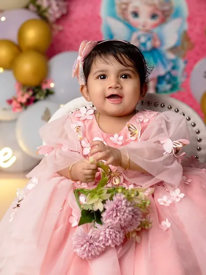 A daughter is a little bit of heaven. This little angel, in her beautiful pink dress, is ready to spread her wings.
