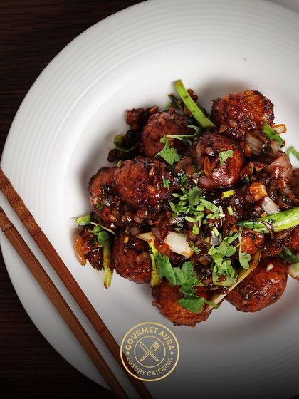 A top-down view of a flavorful Asian dish, showcasing the rich sauce and tender ingredients, perfectly plated on a white dish with chopsticks.