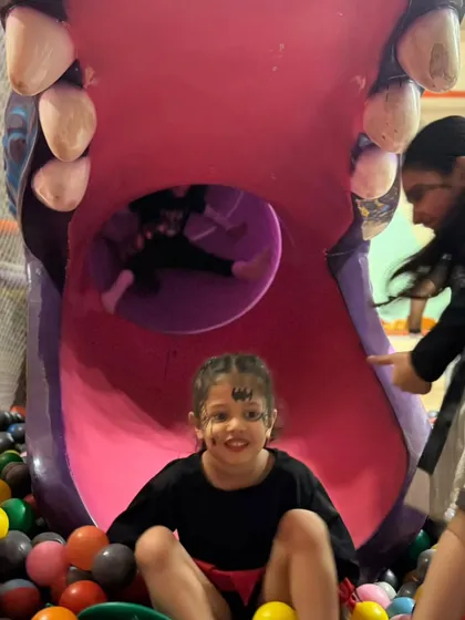 More happy faces in the ball pit. It's a place for endless giggles and fun discoveries.