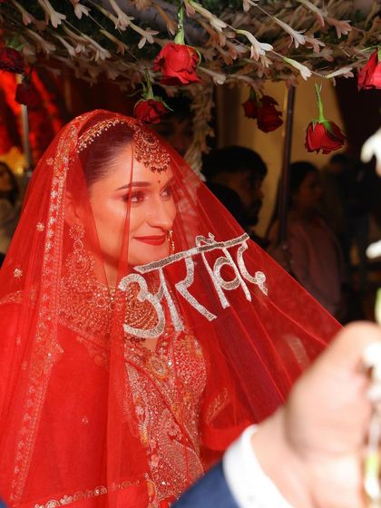 I love how her veil has her groom's name, "Arvind," embroidered on it. It's such a personal and beautiful touch to her bridal look.