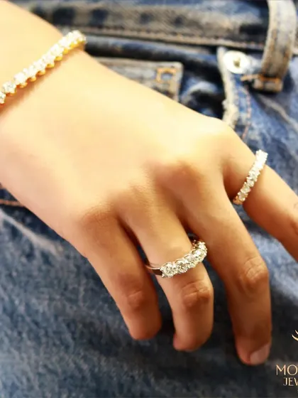 A casual yet chic look, with a model in denim wearing our classic diamond eternity bands and a tennis bracelet.