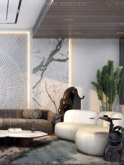 Another view of the Kirti Nagar lounge, showing the large, comfortable sectional sofa and the dramatic, oversized art piece that anchors the room.